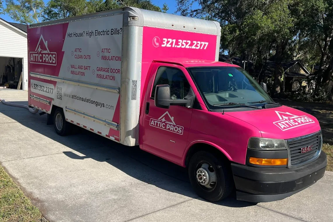 Pink Attic Pros service truck branded with company phone number 321-352-2377